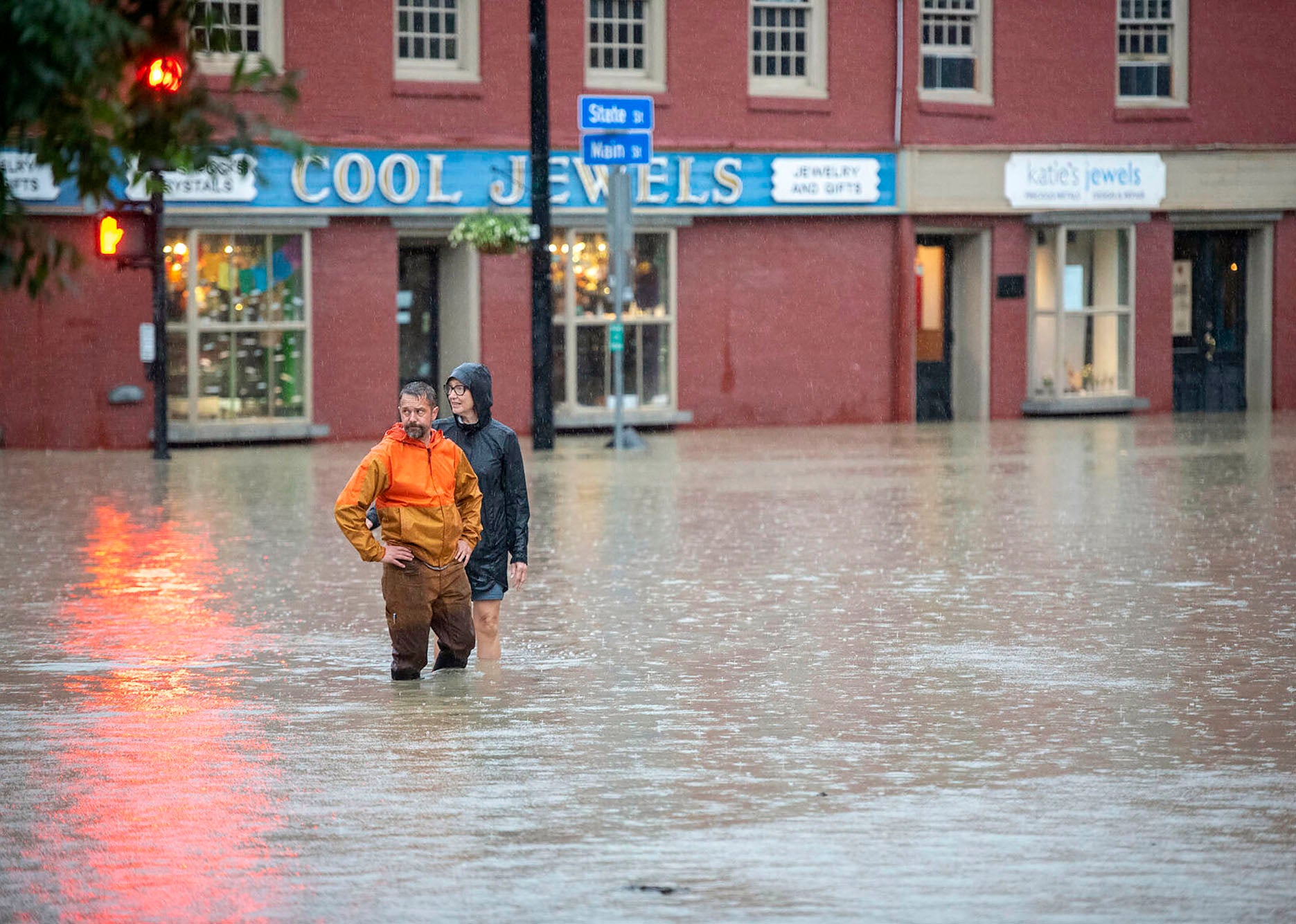 Northeast Flooding Two people stand in knee deep water in flooded town